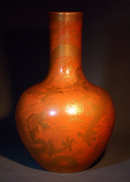 Chinese Qing Porcelain Vase: A porcelain vase painted with gilt dragon and cloud on red-orange ground. Qing dynasty. Jiaqing six-character mark. Size: 18"x9" Starting Bid: 500