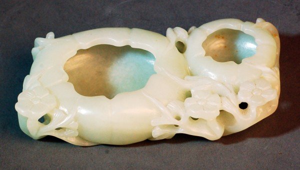 Chinese White Jade Double Well Brush-Washer: Finely carved from an icy white jade of two hollowed containers within the prunus blossom as a long leafy branch with knots and blossom buds. 18th century. Size 4.5" x 2.3" Starting Bid: $600
