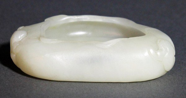 Finely Carved White Jade Brush Washer: Finely carved White Jade Brush Washer in the form of a lotus leaf, carved with two frogs on the side, Length: 3.5", Width: 2.25". Starting Bid: $200