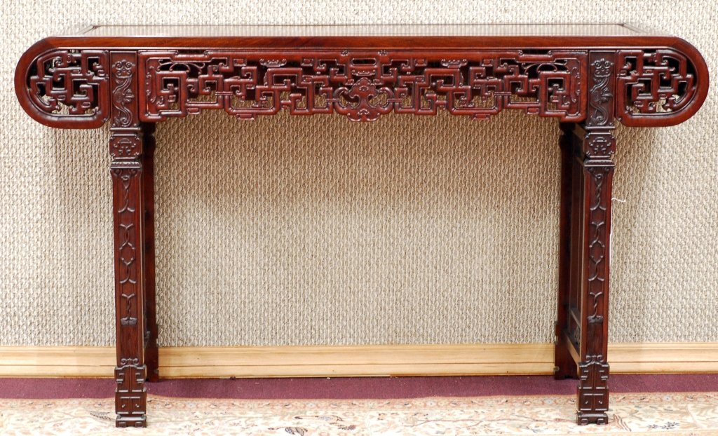 Chinese Redwood AltarTable: A finely carved redwood altar table, carved with open work of characters. Size: 35.5"60" Starting Bid: 700