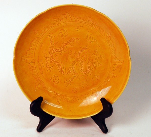 Chinese Yellow Glazed Dragon plat: A porcelain plat carved with dragon and painted allover in royal yellow glaze. "Da Ming HongZhi Nien Zhi" mark at base. Size: 1.5"Hx8.5"Wx8.5"D Starting Bid: 150