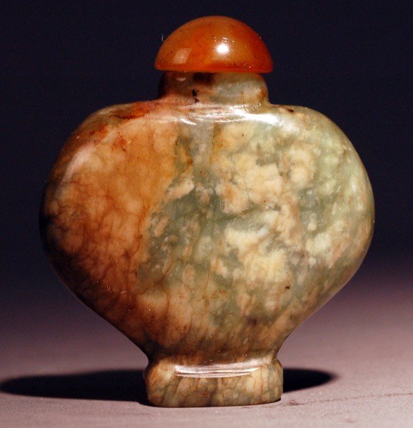 A Yellow-Brownish Jade Snuff Bottle: A Chinese yellow-brownish jade snuff bottle with match stopper, Size : 2.35" X 2.05". Starting Bid: 25