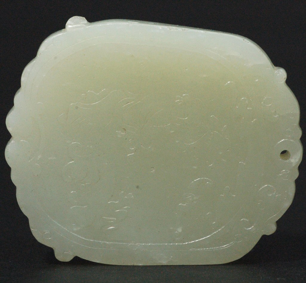 Carved White Jade Plaque: A white jade plaque carved on one side with inscription and reverse side carved with scene of playing boy. L: 2 1/4" , W:1 3/4". Starting Bid: 150