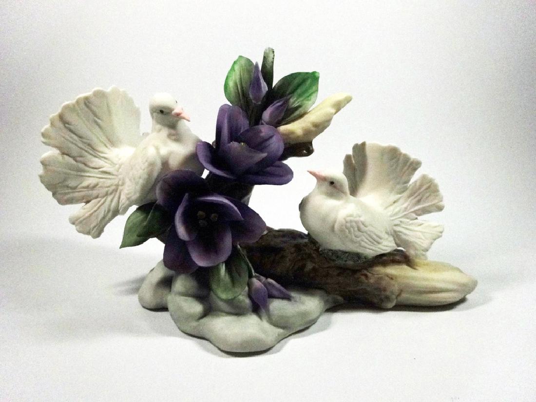 CAPODIMONTE PORCELAIN FLOWERS, 2 DOVES WITH PURPLE: CAPODIMONTE PORCELAIN FLOWERS, 2 DOVES WITH PURPLE FLOWERS, MARKED CAPODIMONTE MADE IN ITALY, APPROX 5.75" X 9.5"