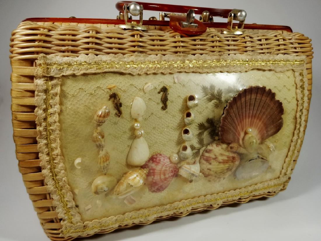 VINTAGE PRINCESS CHARMING BY ATLAS WICKER PURSE, LUCITE: VINTAGE PRINCESS CHARMING BY ATLAS WICKER PURSE, LUCITE HANDLES, SEASHELL MOTIF, SOME CRACKS TO PLASTIC, APPROX 8.75" X 12.5" X 4.25"
