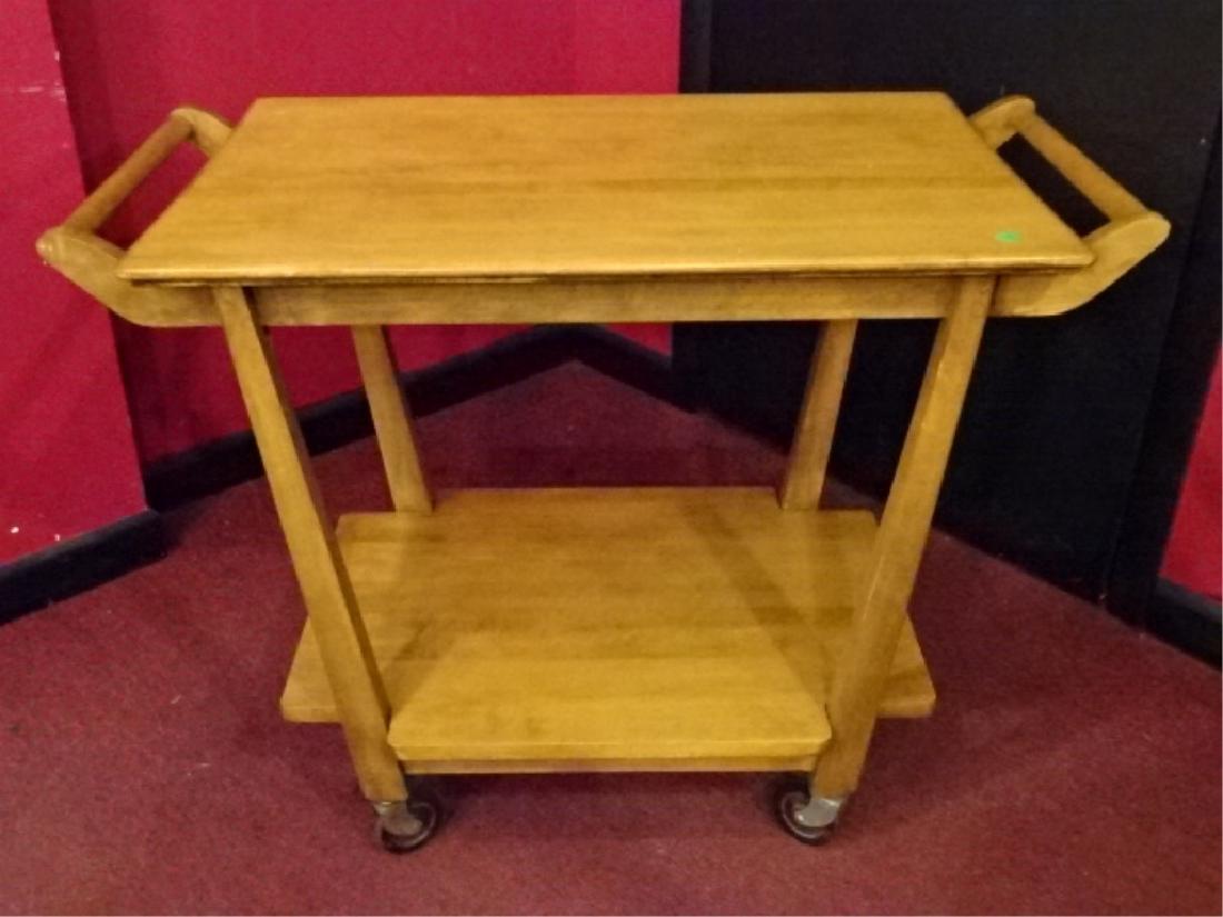 MID CENTURY MODERN SERVING CART, JOHN WIDDICOMB STYLE,: MID CENTURY MODERN SERVING CART, JOHN WIDDICOMB STYLE, WITH UNDER TIER AND CASTERS, VERY GOOD CONDITION, BLONDE FINISH, 36"W X 20"D X 27.5"H, SKU355.01