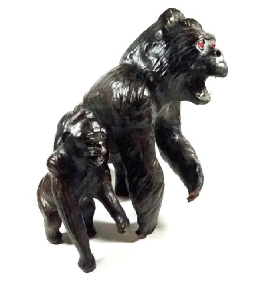 2 PC LEATHER WRAPPED GORILLA SCULPTURES, WEAR TO HAND: 2 PC LEATHER WRAPPED GORILLA SCULPTURES, WEAR TO HAND OF LARGER, MISSING TEETH TO SMALLER, LARGER APPROX 11"H, SMALLER APPROX 7"H