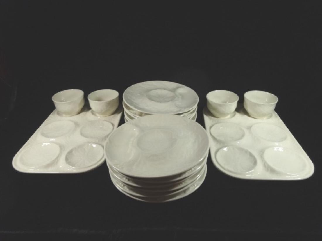 18 PC VINTAGE FRENCH WHITE MAJOLICA ARTICHOKE SERVICE,: 18 PC VINTAGE FRENCH WHITE MAJOLICA ARTICHOKE SERVICE, MARKED GIEN FRANCE, INCLUDES 12 PLATES WITH WELLS FOR ARTICHOKE, SAUCE & LEAVES, 4 BOWLS WITH ARTICHOKE LEAF DESIGN, AND 2 TRAYS WITH 6 WELLS; PL