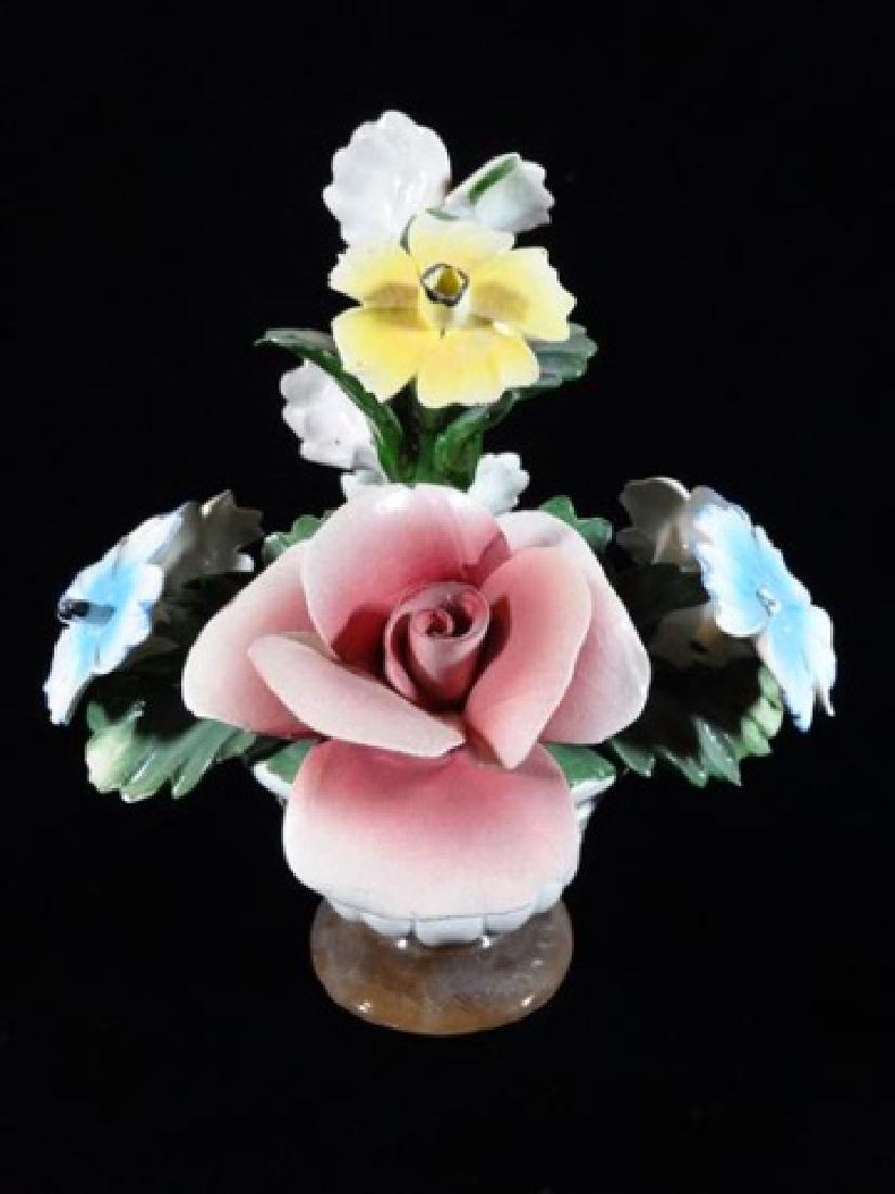 CAPODIMONTE ITALIAN PORCELAIN FLOWERS IN ROUND PEDESTAL: CAPODIMONTE ITALIAN PORCELAIN FLOWERS IN ROUND PEDESTAL VASE, WITH N AND CROWN MARK, MADE IN ITALY, VERY GOOD CONDITION WITH A COUPLE MINOR CHIPS TO PETALS, 10"H X 8"W, SKU454.23