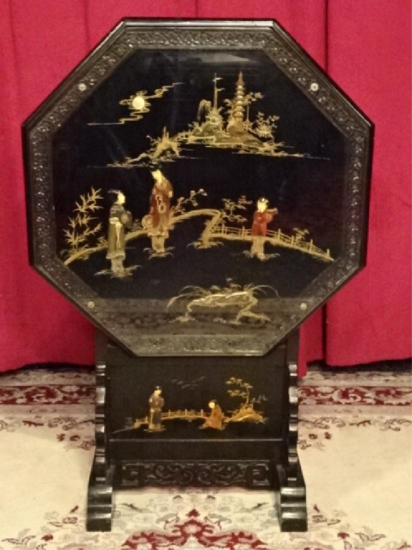 CHINESE WOOD OCTAGONAL TILT TABLE, BLACK ENAMEL FINISH: CHINESE WOOD OCTAGONAL TILT TABLE, BLACK ENAMEL FINISH WITH COMPOSITE APPLIQUE FIGURES, GLASS TOP, VERY GOOD CONDITION, 24" X 24" WHEN TOP DOWN, 36"H WITH TOP IN UPRIGHT POSITION, SKU495.20 P50
