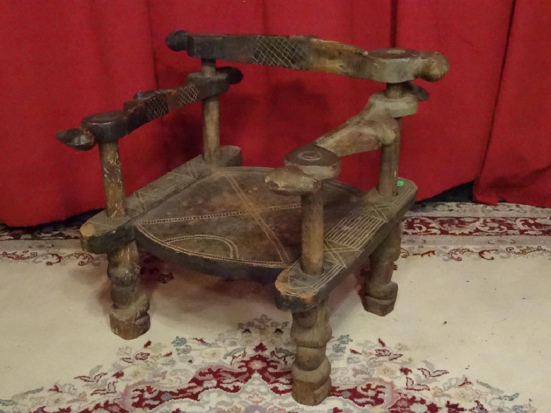 ANTIQUE AFRICAN LOW ARMCHAIR, CARVED WOOD WITH BIRDS ON: ANTIQUE AFRICAN LOW ARMCHAIR, CARVED WOOD WITH BIRDS ON ARMS AND SEAT BACK, GOOD CONDITION WITH SOME WEAR COMMENSURATE WITH AGE, 24"W X 23"H X 20"D, SKU496.67 P40