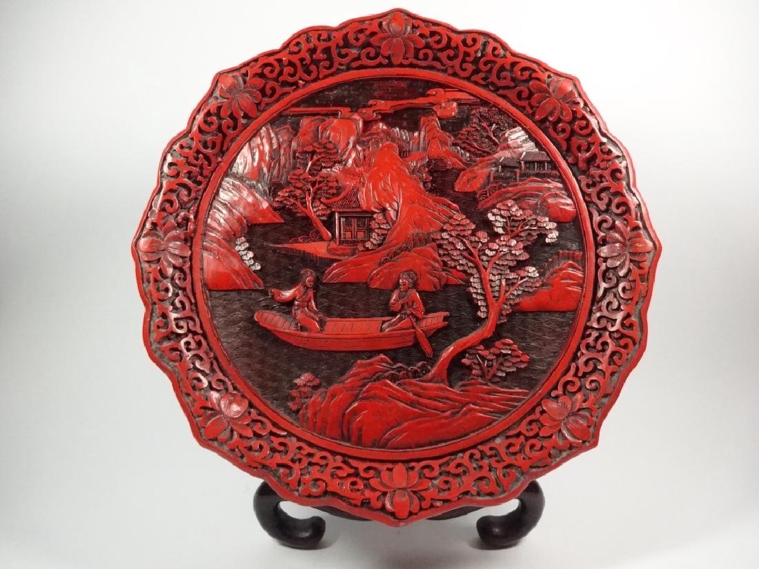 CINNABAR FINISH CARVED WOOD PLATTER, MADE IN TAIWAN,: CINNABAR FINISH CARVED WOOD PLATTER, MADE IN TAIWAN, APPROX 9.75" DIAMETER, STAND INCLUDED