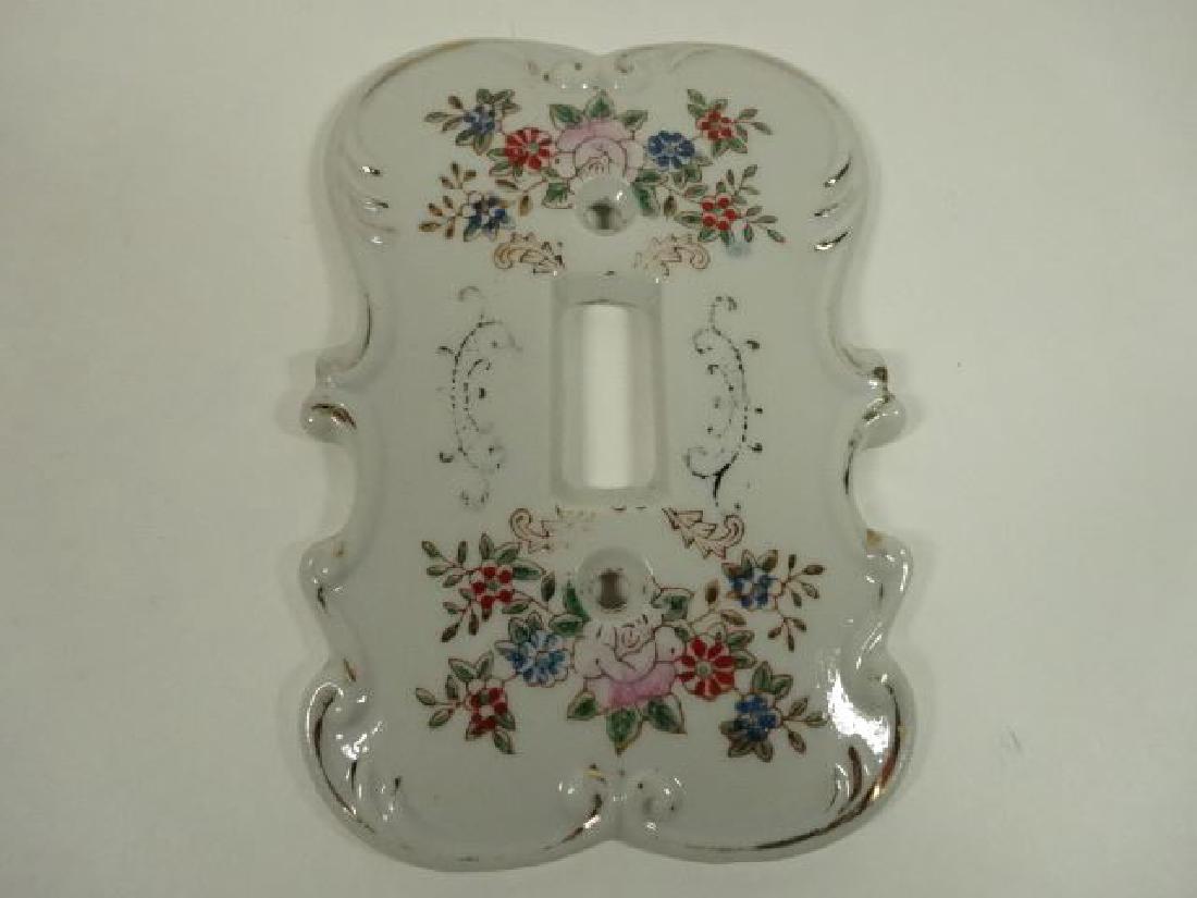PORCELAIN SWITCH PLATE WITH PAINTED FLORALS, WITH: PORCELAIN SWITCH PLATE WITH PAINTED FLORALS, WITH CROSSED ARROW MARK ON BACK VERY GOOD CONDITION, 5" X 4", SKU604.12