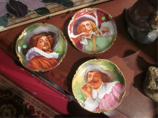 THREE ANTIQUE LIMOGES CAVALIER PORTRAIT CHARGER PL: THREE ANTIQUE LIMOGES CAVALIER PORTRAIT CHARGER PLATES, APPROX 10 3/4" DIAMETER, SIGNED BY ARTIST L. COUDERT, WITH BACK STAMPS OF BOTH MAVALEIX DATING 1908-1914 AND BORGFELDT MARK 1 DATING 1906-1920. 