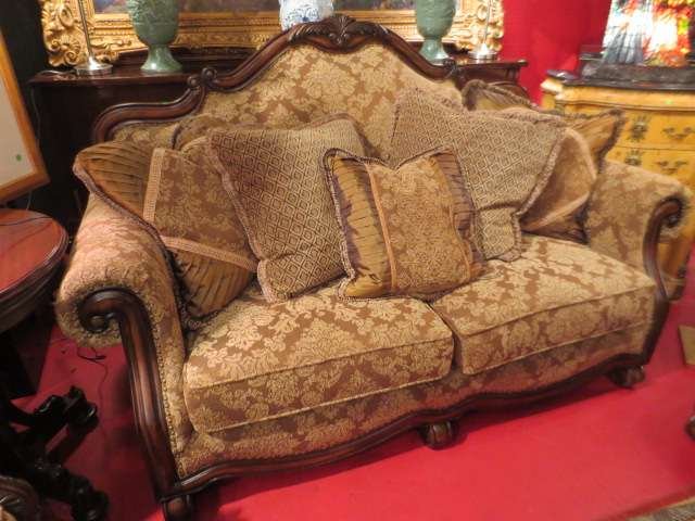 OPULENT LOVESEAT, DARK WOOD FRAME, TAN AND CREAM U: OPULENT LOVESEAT, DARK WOOD FRAME, TAN AND CREAM UPHOLSTERY WITH COORDINATING PLEATED AND FRINGED THROW PILLOWS, LIKE NEW CONDITION, (SECOND MATCHING LOVESEAT, CHAIR, AND SOFA SOLD SEPARATELY)