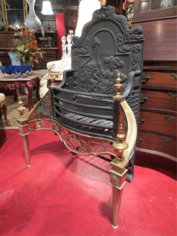 ANTIQUE BRASS AND IRON FIREPLACE GRATE, 19TH CENTU: ANTIQUE BRASS AND IRON FIREPLACE GRATE, 19TH CENTURY, WITH FINIALED COLUMNS FLANKING THE BASKET, IRON FIGURAL RELIEF, APPROX 3' L, 2.5' H