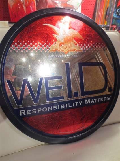 MIRRORED BAR SIGN, "WE I.D. - DRINK RESPONSIBLY" FROM A: MIRRORED BAR SIGN, "WE I.D. - DRINK RESPONSIBLY" FROM ANHEUSER-BUSCH, WITH METALLIC LOGO, APPROX 20" DIAMETER
