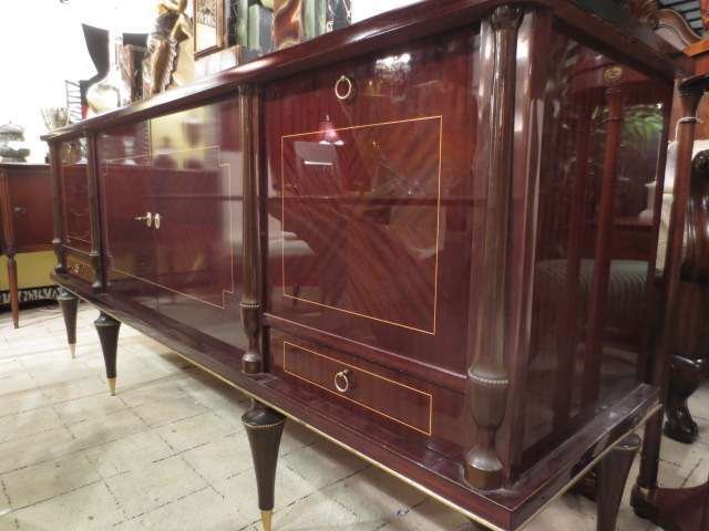 FRENCH MIDCENTURY MACASSAR EBONY SIDEBOARD, CIRCA 1940': FRENCH MIDCENTURY MACASSAR EBONY SIDEBOARD, CIRCA 1940's. FOUR DOORS, BRASS ACCENTS, TAPERED LEGS ENDING IN BRASS SABOTS, VERY GOOD CONDITION, ONE SMALL LOWER PANEL ON BACK RIGHT HAS SOME VENEER LOSS,
