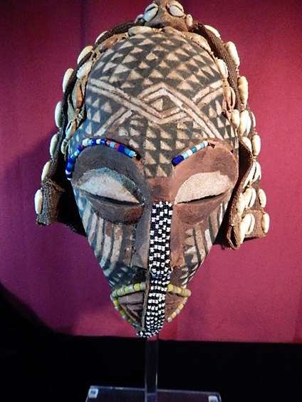 AFRICAN CARVED WOODEN MASK WITH PATTERN-PAINTED FACE,: AFRICAN CARVED WOODEN MASK WITH PATTERN-PAINTED FACE, HEAD COVERED W/COWRIE SHELLS, YELLOW & WHITE BEADS SURROUND MOUTH, FROM KASAI TRIBE, ZAIRE (DEMOCRATIC REPUBLIC OF THE CONGO), AFRICA, APPROX 11"H