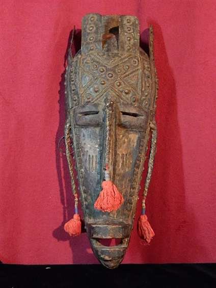 AFRICAN CARVED WOODEN MASK, FACE COVERED WITH METAL,: AFRICAN CARVED WOODEN MASK, FACE COVERED WITH METAL, RED TASSELS ATTACHED TO NOSE & EARS, FROM BAMBARA TRIBE, WEST AFRICA, APPROX 18.5"H