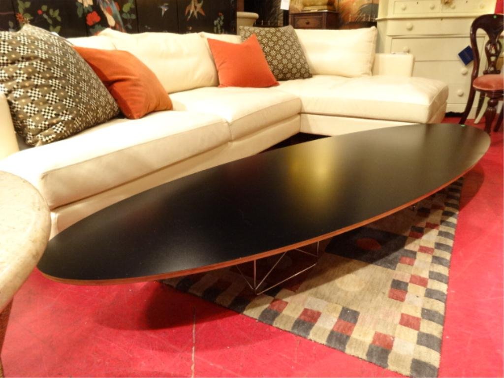 EAMES SURFBOARD COFFEE TABLE BY HERMAN MILLER, BLACK: EAMES ETR SURFBOARD COFFEE TABLE BY HERMAN MILLER, BLACK LAMINATE ELLIPTICAL WOOD TOP, 2 CHROME WIRE STRUT BASES, RECENT PRODUCTION, LABELED EAMES HERMAN MILLER, 89"W X 29.5"D X 10"H, LIGHT SCRATCH TO