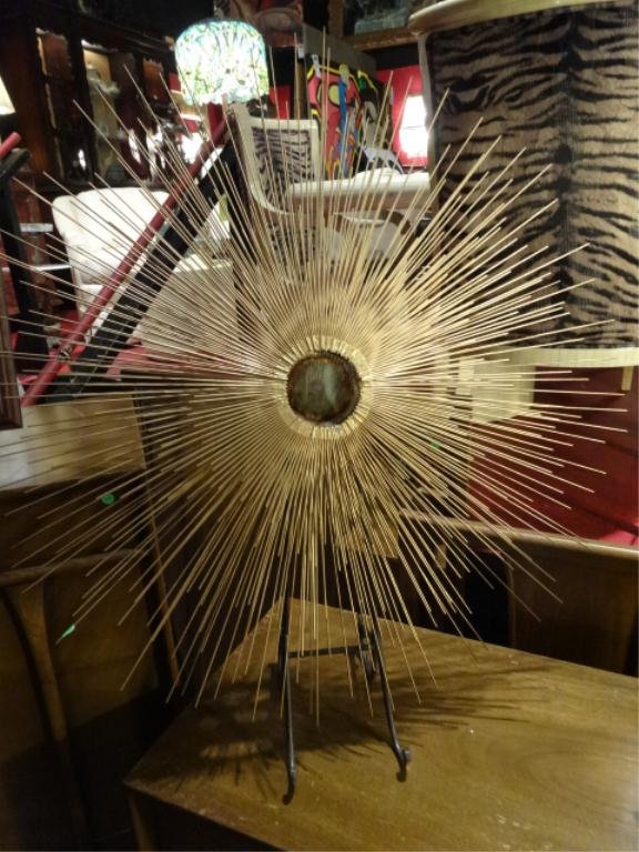CURTIS JERE STYLE SUNBURST WALL SCULPTURE, MID CENTURY,: CURTIS JERE STYLE SUNBURST WALL SCULPTURE, MID CENTURY IN THE STYLE OF CURTIS JERE OR HARRY BERTOIA, LAYERED INSET BRASS CENTER WITH RADIATING SPIKES OF PATINATED METAL RODS, APPROX 26" DIAMETER