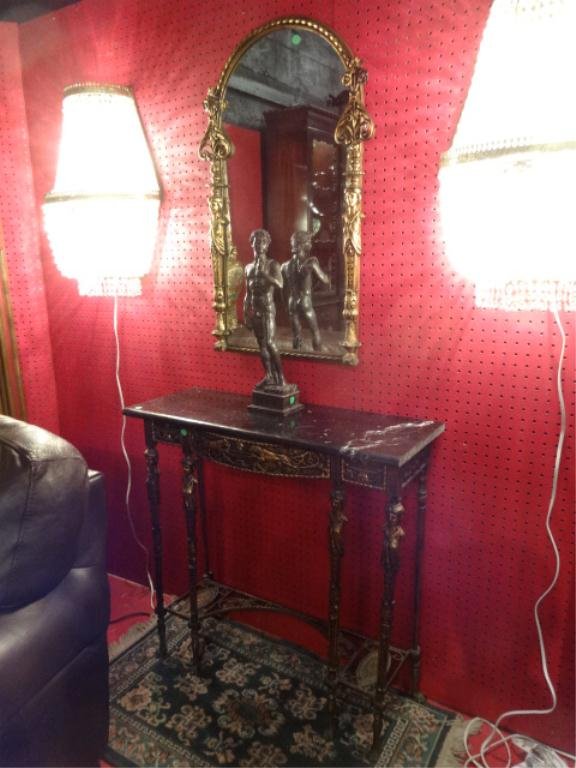 NEOCLASSICAL GILT METAL FOYER TABLE AND MIRROR, BLACK: NEOCLASSICAL GILT METAL FOYER TABLE AND MIRROR, BLACK MARBLE TOP, FIGURAL ACCENTS ON LEGS AND MIRROR, CAST LIONS ON APRON, BLACK MARBLE TOP, TABLE APPROX 3'W X 10"D X 30"H, MIRROR APROX 2.5' X 14", SK