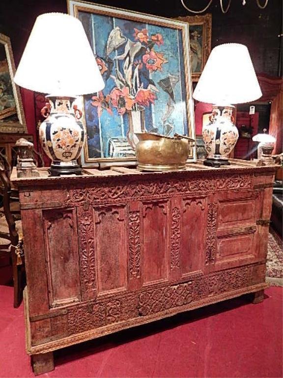ANTIQUE BALINESE WOOD WEDDING CHEST, CIRCA 19TH: ANTIQUE BALINESE WOOD WEDDING CHEST, CIRCA 19TH CENTURY, (PROVENANCE: JERE'S ANTIQUES, SAVANNAH, GA) INTRICATELY CARVED, IRON HARDWARE, RED FINISH ON FRONT, 2 HIDDEN DRAWERS IN BASE, FINIALS ON TOP, A