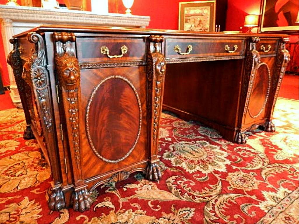 MAITLAND SMITH MAHOGANY PARTNERS DESK, CARVED WOOD WITH: MAITLAND SMITH MAHOGANY PARTNERS DESK, CARVED WOOD WITH LION'S HEAD ORNAMENTATION, LEATHER TOP, EXCELLENT CONDITION, LABELED MAITLAND SMITH, 75"W X 42"D X 30"H