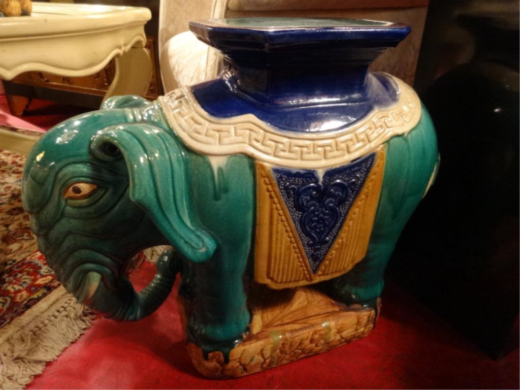 PORCELAIN ELEPHANT GARDEN STOOL, GREEN WITH YELLOW AND: PORCELAIN ELEPHANT GARDEN STOOL, GREEN WITH YELLOW AND PURPLE SADDLE, CHIP IN BACK OF SADDLE AS SHOWN IN PHOTO #4, APPROX 25"W, #2 OF TWO AVAILABLE, EACH SOLD SEPARATELY