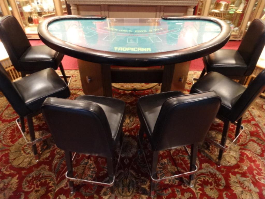 VINTAGE TROPICANA HOTEL BLACKJACK TABLE, WITH 6 BLACK: VINTAGE TROPICANA HOTEL BLACKJACK TABLE, WITH 6 BLACK VINYL BARSTOOLS WITH CHROME ACCENTS, TABLE TOP HAS BE FITTED WITH PLEXIGLASS TOP FOR OPTIONAL USE AS A HOME BAR, VERY GOOD CONDITION, ONE BARSTOOL