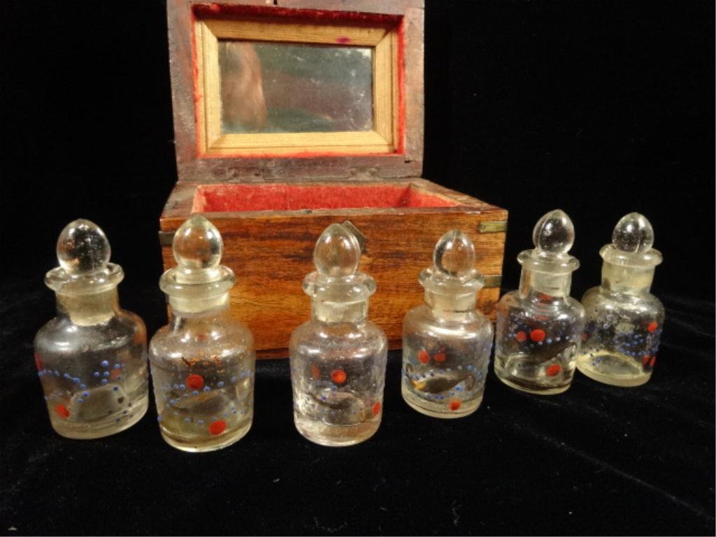 ANTIQUE INDIAN SCENT CASKET / PERFUME BOX WITH SIX: ANTIQUE INDIAN SCENT CASKET / PERFUME BOX WITH SIX BOTTLES HAND DECORATED IN ENAMEL AND GOLD. ALL BOTTLES HAVE STOPPERS. SOME STOPPERS HAVE CHIPS TO THE BASE. BOX MEASURES APPROX 3.5" X 4" X 5.5", SKU