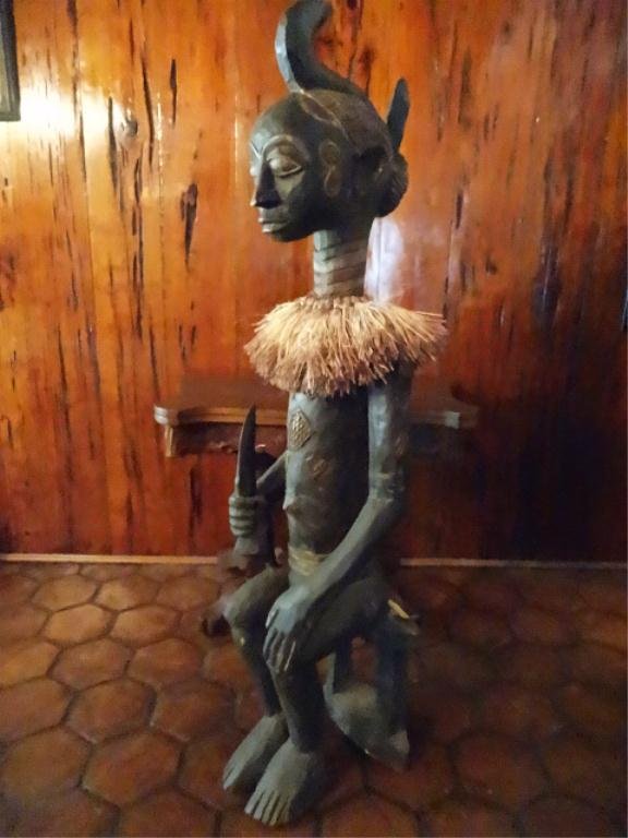 LARGE AFRICAN CARVED WOOD STATUE FROM MALONBA, CONGO,: LARGE AFRICAN CARVED WOOD STATUE FROM MALONBA, CONGO, SEATED CHIEF HOLDING SPEAR AS SYMBOL OF POWER, APPROC 5'H, SKU581.78