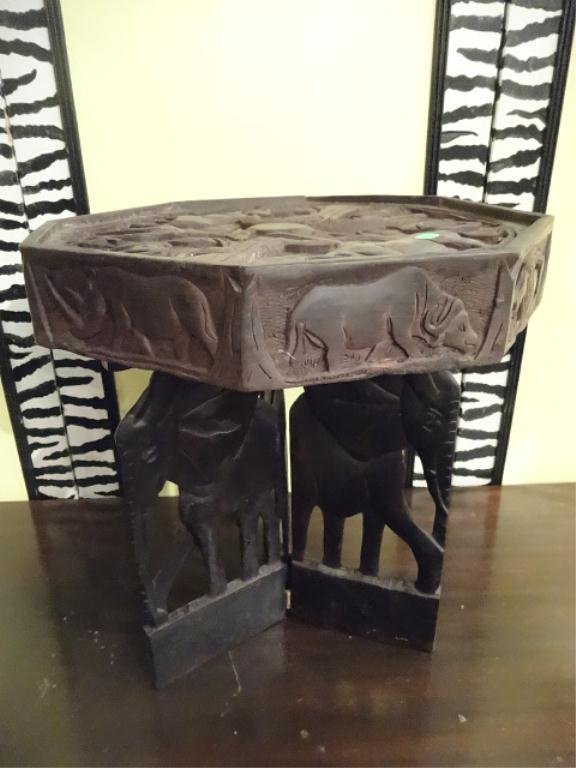 AFRICAN CARVED WOOD TABLE, OCTAGONAL TOP CARVED WITH: AFRICAN CARVED WOOD TABLE, OCTAGONAL TOP CARVED WITH ANIMALS AND PLANTS, ELEPHANT FIGURAL BASE, APPROX 16.5"W X 18.5"H, SKU744.30