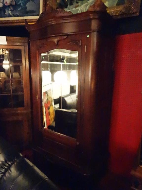 ANTIQUE GERMAN ARMOIRE, CORNICE CARVED WITH FOLIATE: ANTIQUE GERMAN ARMOIRE, CORNICE CARVED WITH FOLIATE SCROLLS, MIRRORED DOOR, BRASS NORTH WIND FACE ESCUTCHEON WITH KEY, SINGLE DRAWER BASE WITH BRASS PULLS, DISASSEMBLES FOR MOVING, APPROX 7.5'H X 4'W,