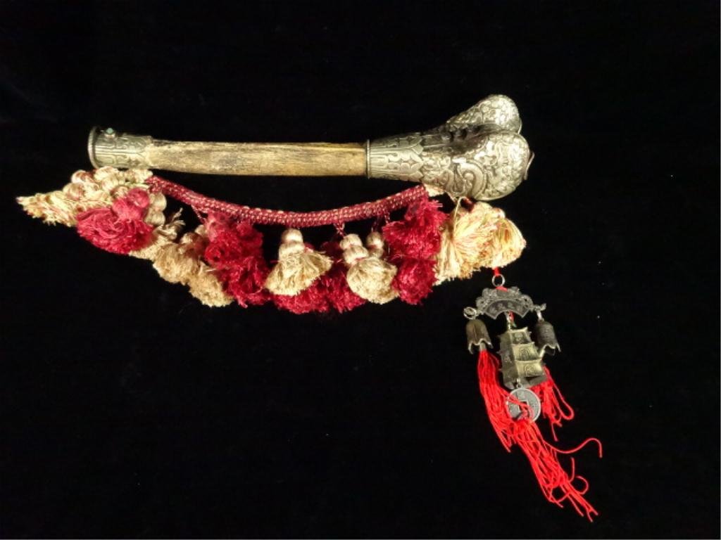 ANTIQUE TIBETAN KANGLING HUMAN THIGH BONE HORN, USED IN: ANTIQUE TIBETAN KANGLING HUMAN THIGH BONE HORN, USED IN TANTRIC HIMALAYAN BUDDHIST SACRED RITUALS, DECORATED IN SEMI-PRECIOUS STONE WITH REPOUSSE METALWORK, WITH TASSELED CORD, APPROX 13.5"L