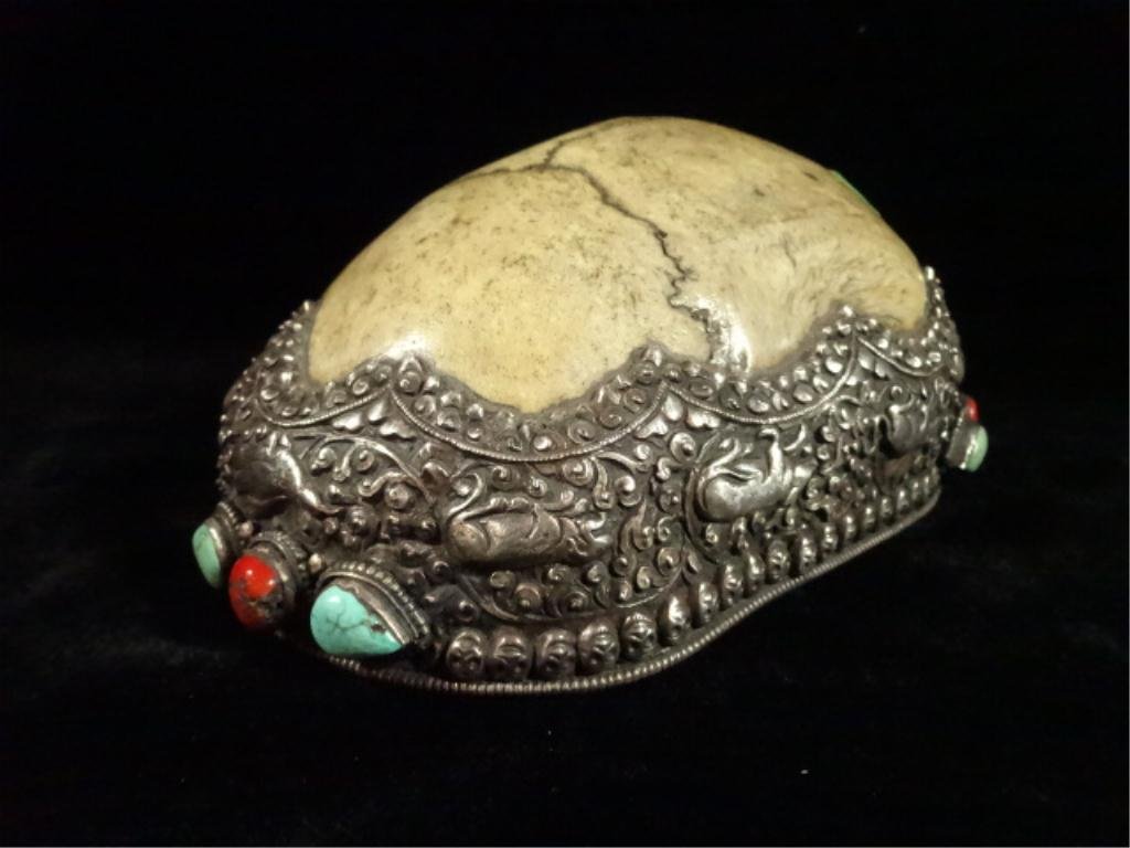ANTIQUE TIBETAN KAPALA SACRED HUMAN SKULL CAP,: ANTIQUE TIBETAN KAPALA SACRED HUMAN SKULL CAP, DECORATED IN SEMI-PRECIOUS STONE WITH REPOUSSE METALWORK, USED IN TANTRIC HIMALAYAN BUDDHIST SACRED RITUALS, APPROX 3" X 5.25" X 7.5"