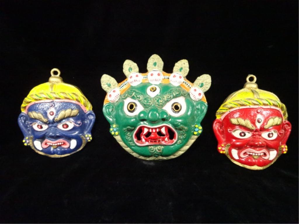 3 PAINTED METAL BALINESE MASK WALL PLAQUES, TWO APPROX: 3 PAINTED METAL BALINESE MASK WALL PLAQUES, TWO APPROX 6" X 5", ONE APPROX 6.75" X 7"
