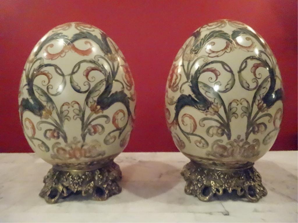 PAIR BRONZE AND PORCELAIN EGGS, PAINTED FOLIATE DESIGNS: PAIR BRONZE AND PORCELAIN EGGS, PAINTED FOLIATE DESIGNS ON ORNATE BASES, 8"H, SKU926.20