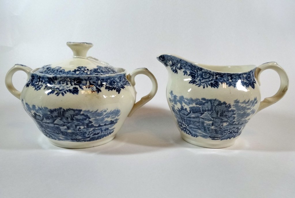 2 PC BLUE AND WHITE STAFFORDSHIRE CREAMER AND SUGAR,: 2 PC BLUE AND WHITE STAFFORDSHIRE CREAMER AND SUGAR, COLONIAL VILLAGE PATTERN, MARKED SALEM CHINA CO, ENGLAND, IRONSTONE, 6.5" X 4" AND 5.5" X 3.5"
