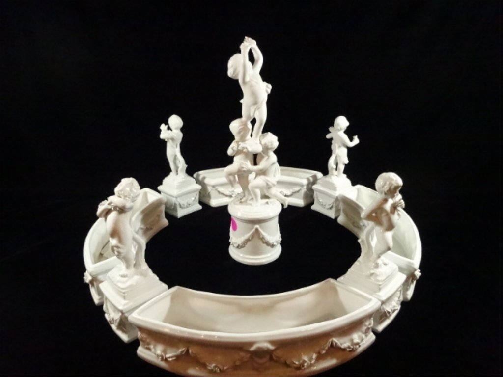 NINE (9) PIECE MOTTAHEDEH DESIGN MADE IN ITALY BLANC DE: NINE (9) PIECE MOTTAHEDEH DESIGN MADE IN ITALY BLANC DE CHINE PORCELAIN CENTERPIECE, FOUR SEASONS. SIGNED. GOOD CONDITION, TIP OF INDEX FINGER ON CENTER SCULPTURE MISSING. CENTER SCULPTURE MEASURES 11