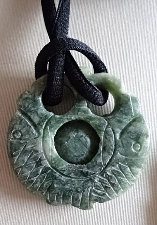 CARVED HARDSTONE PENDANT, ON BLACK CORD WITH GOLD TONE: CARVED HARDSTONE PENDANT, ON BLACK CORD WITH GOLD TONE ENDS, APPROX 2" DIAMETER, SKU895.P2
