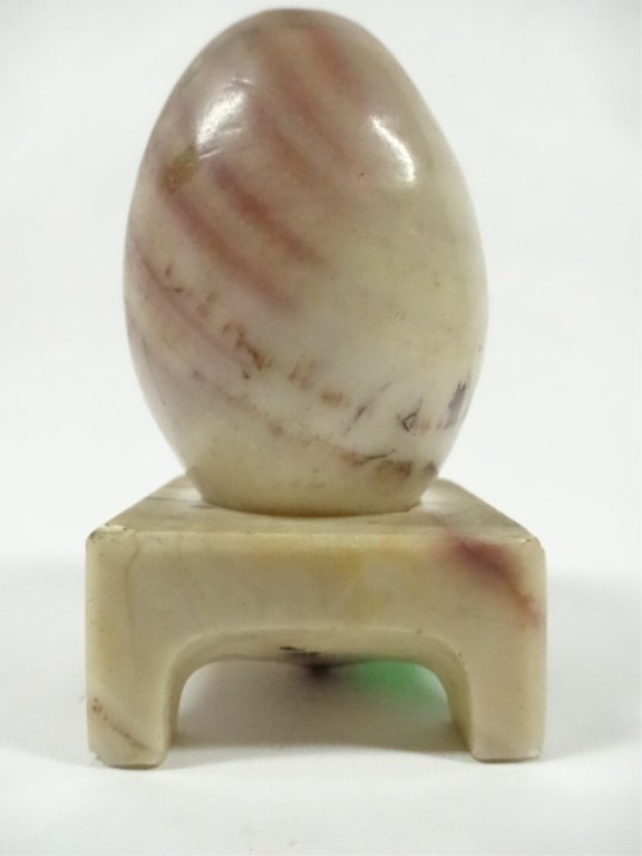 CARVED STONE EGG ON STONE STAND, SMALL CHIP TO STAND,: CARVED STONE EGG ON STONE STAND, SMALL CHIP TO STAND, APPROX 3"H