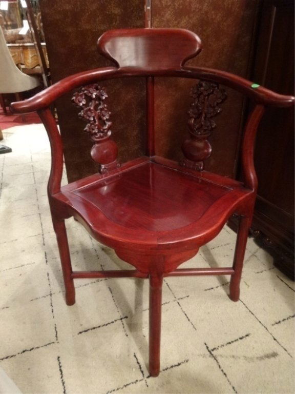 CHINESE ROSEWOOD CORNER CHAIR, MODERN, CARVED WITH A: CHINESE ROSEWOOD CORNER CHAIR, MODERN, CARVED WITH A YOKE SHAPED BACK REST, CARVED VASES AND FLOWERS, SQUAREED LEGS JOINED BY AN X FORM STRETCHER, EXCELLENT GENTLY USED CONDITION, APPROX 33.5"H X 29"W