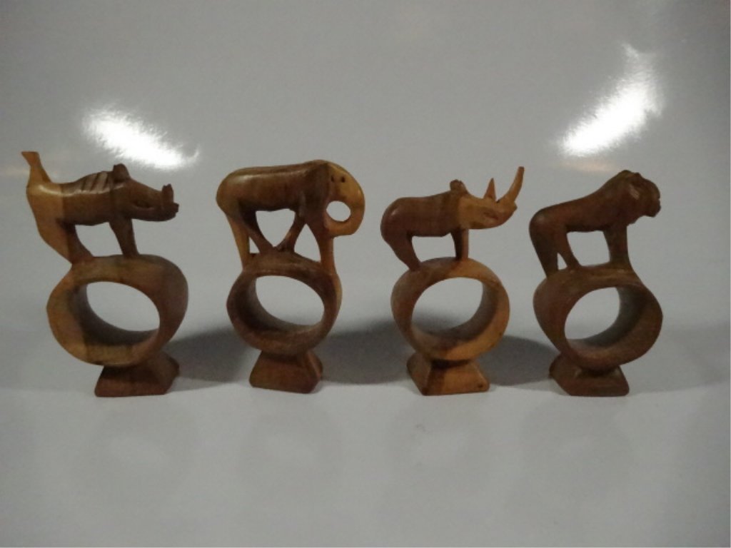 4 PC CARVED WOOD NAPKIN RINGS, INCLUDES LION, ELEPHANT,: 4 PC CARVED WOOD NAPKIN RINGS, INCLUDES LION, ELEPHANT, RHINO & WARTHOG, APPROX 4.25"H