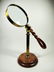 LARGE MAGNIFYING GLASS ON STAND, CARVED WOOD HANDLE IN