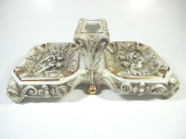 R. CAPODIMONTE DUAL ASHTRAY WITH CIGARETTE HOLDER: R. CAPODIMONTE DUAL ASHTRAY WITH CIGARETTE HOLDER CENTER, APPROX 3.75" X 9.75" X 5.75"