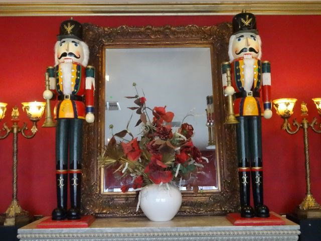 PAIR HUGE WOODEN CHRISTMAS NUTCRACKERS, EACH HOLDING: PAIR HUGE WOODEN CHRISTMAS NUTCRACKERS, EACH HOLDING HORNS, VERY GOOD GENTLY USED CONDITION WITH ONE MISSING PLASTIC BUTTON (SEE PHOTO), 58"H, SKU90.01 BX003