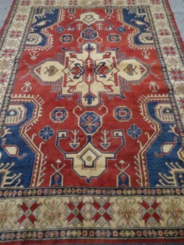 LARGE MIDDLE EASTERN WOOL RUG, RED FIELD WITH BLUE AND (1 of 5)