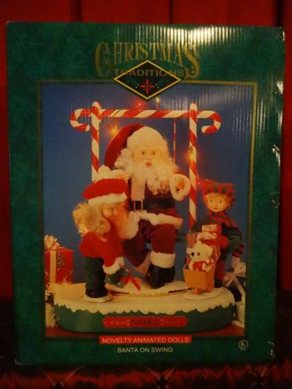 ANIMATED CHRISTMAS SANTA FIGURE ON SWING, IN ORIGINAL: ANIMATED CHRISTMAS SANTA FIGURE ON SWING, IN ORIGINAL BOX, VERY GOOD WORKING CONDITION, FIGURE APPROX 24" X 19" X 11". SKU950.33 BX066